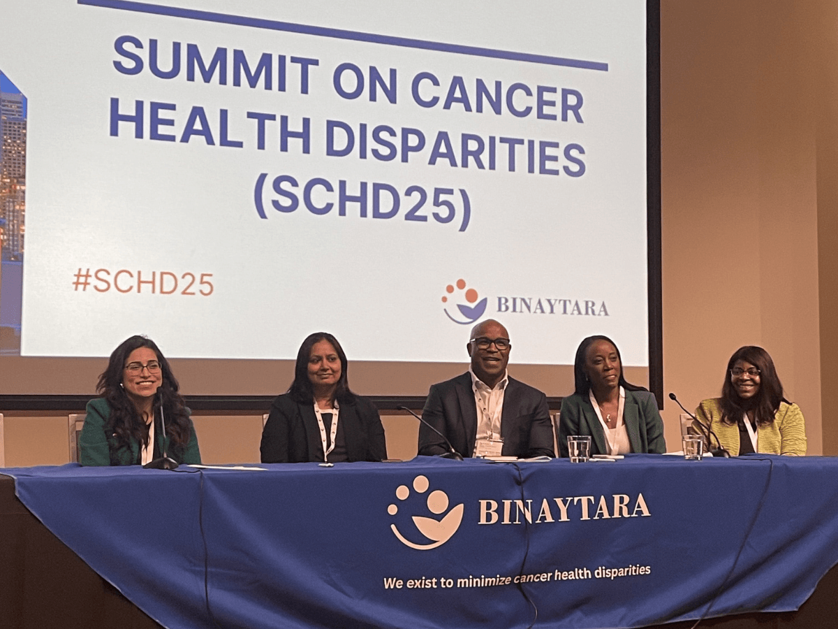 Panelists at SCHD25 Day 2 discuss AI innovations, community engagement, and global oncology strategies, seated behind a Binaytara banner with the Summit on Cancer Health Disparities screen in the background.