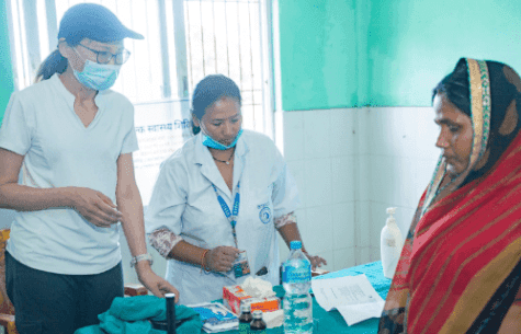 A female doctor and nurse preparing supplies during a cervical cancer screening program in Nepal.