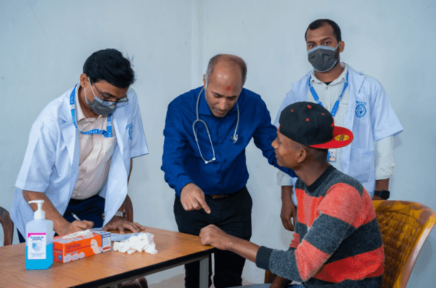 Dr. Binay Shah consults with a patient alongside Binaytara medical staff at a free health camp in Nepal.