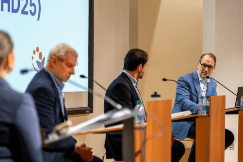 Dr. E. Anders Kolb speaking with fellow panelists during the SCHD25 closing debate on cancer health disparities.