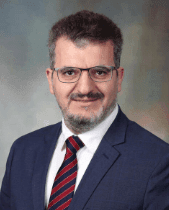 Dr. Yousef Zakharia, a medical oncologist specializing in genitourinary cancers, wearing a suit and glasses.