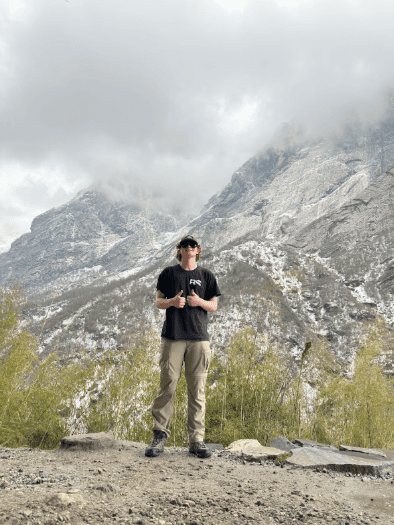 Montana State University freshman Jonathan Marquart stands on a Himalayan trail in Nepal, raising awareness for global health and cancer care disparities.