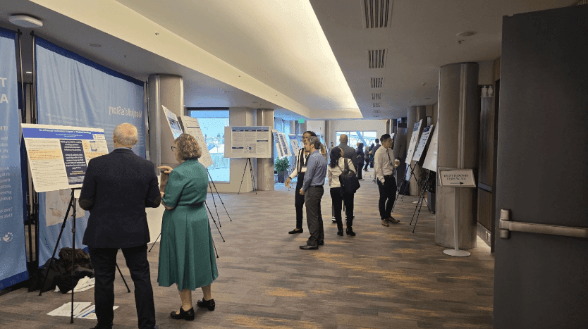 Attendees view poster presentations at SCHD25 showcasing innovations in cancer health disparities, breast cancer screening, cervical cancer prevention, and access to blood cancer therapies.