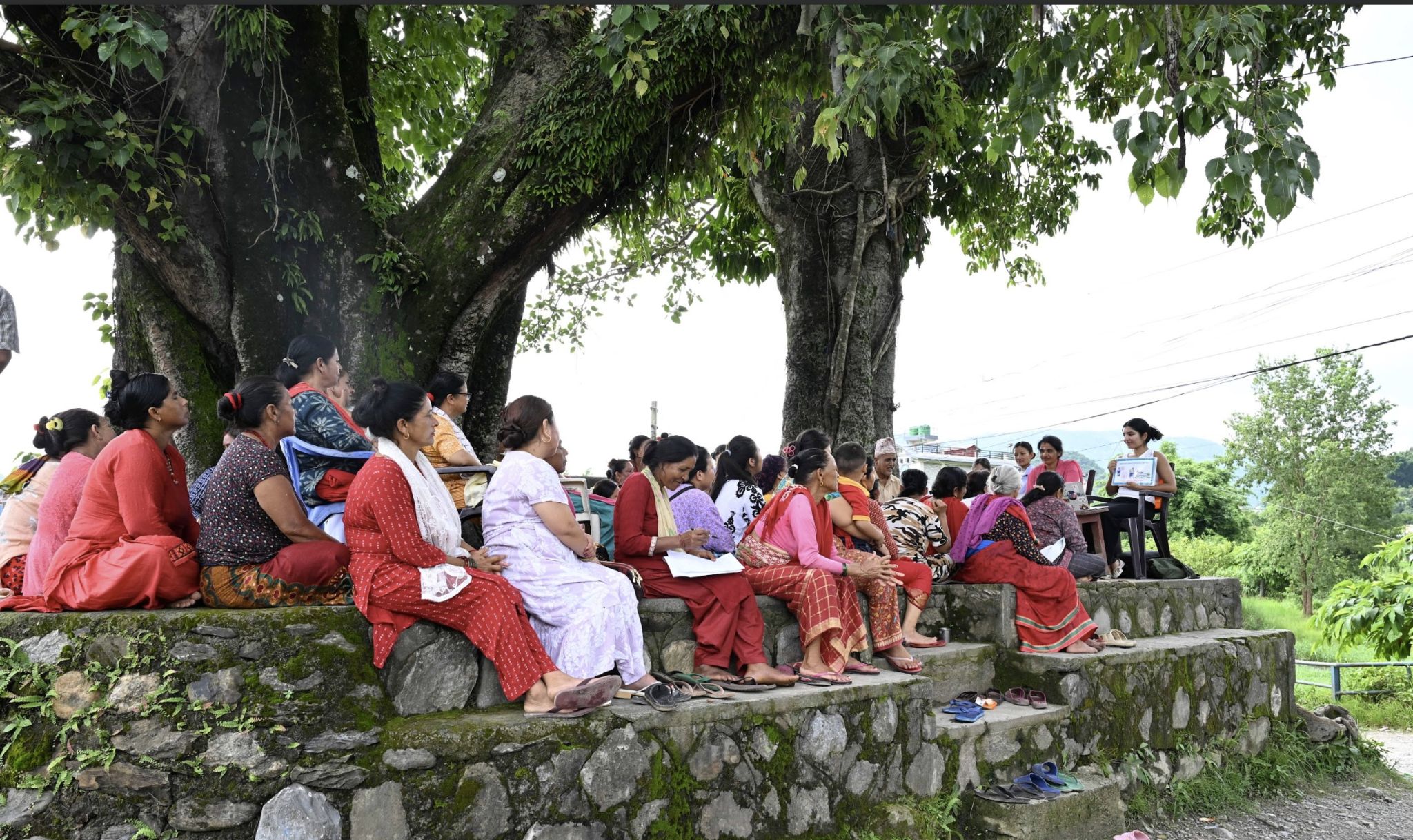 Women attending a cervical cancer awareness camp under a large tree in Eklekuna, Lekhnath, Nepal.