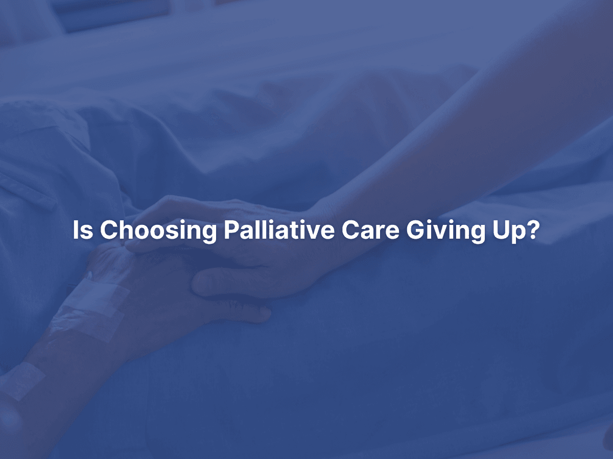 A supportive hand rests on a patient’s arm in a hospital bed, representing compassionate palliative care.